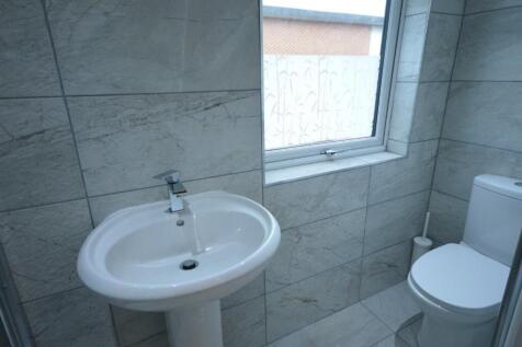 Modern bathroom featuring elegant tiles, a slee...