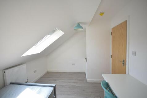 A bright and inviting double bedroom with moder...