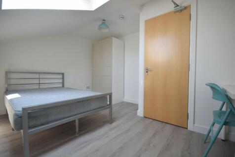 A bright and tidy double bedroom featuring mode...