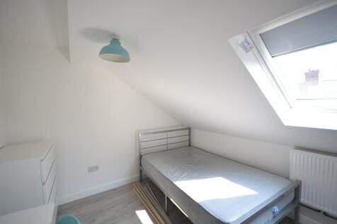 A bright and airy double bedroom with a spaciou...