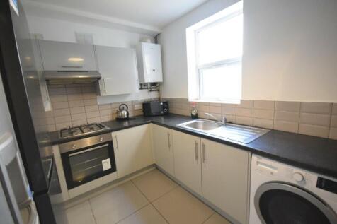 A modern and clean kitchenette with ample stora...