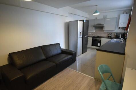 A modern kitchenette with sleek appliances and ...