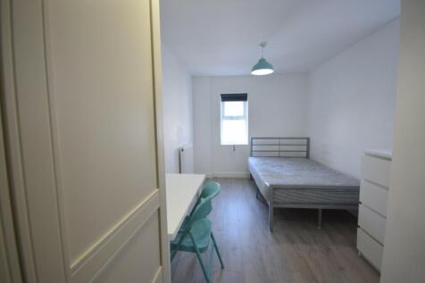 A bright and tidy double bedroom featuring a co...