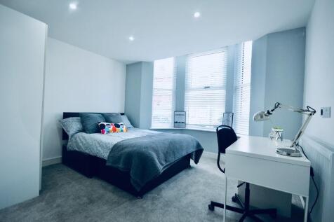Bright and spacious double bedroom featuring la...