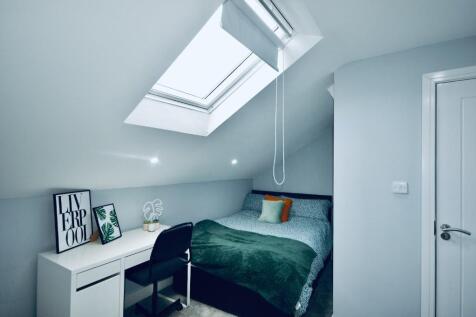 This inviting double bedroom features a cozy la...