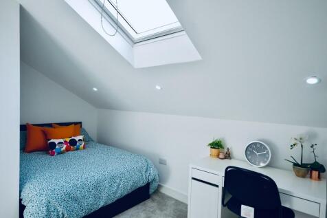 Bright and cozy double bedroom featuring a comf...