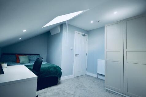 Cozy double bedroom featuring ample natural lig...
