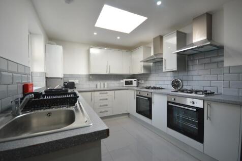 This modern kitchen features sleek cabinetry an...