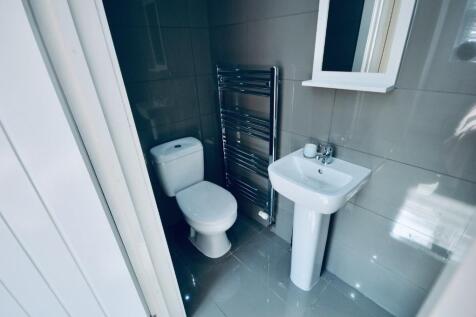 A modern bathroom featuring sleek fixtures, a s...