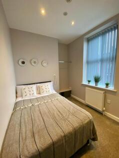 A bright and inviting double bedroom with moder...