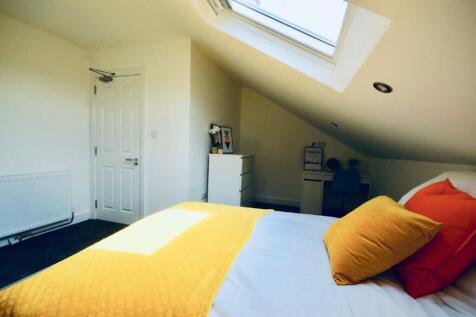 This cozy double bedroom features a bright and ...