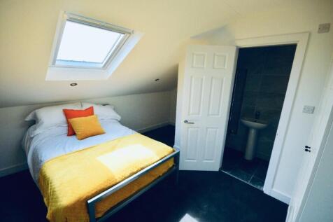 This inviting double bedroom features a cozy la...