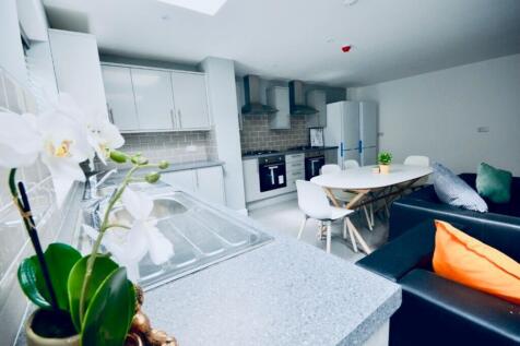 A modern kitchen featuring sleek cabinetry and ...