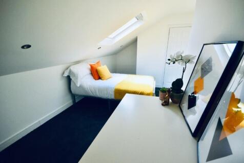 This cozy double bedroom features a comfortable...