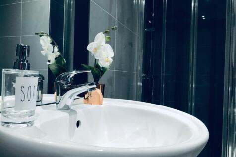 This modern bathroom features a sleek design wi...