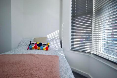 A bright and inviting double bedroom with ample...