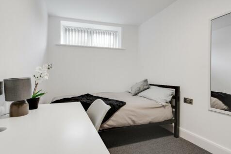 This cozy double bedroom features a comfortable...