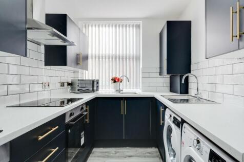 Modern kitchen with sleek cabinetry and ample n...