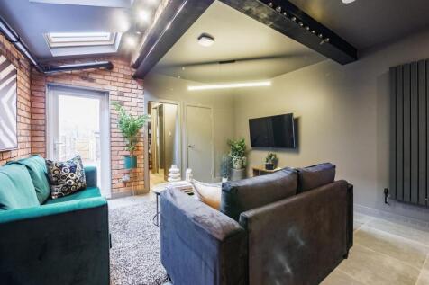 A stylish contemporary living room with exposed...