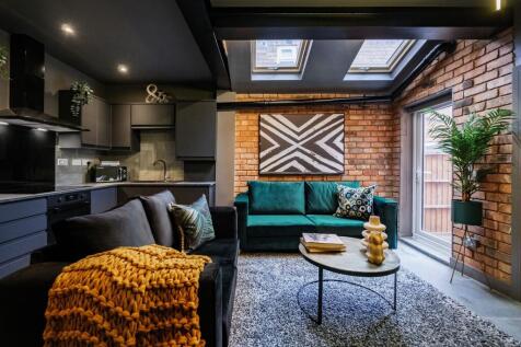 Contemporary living room with stylish exposed b...