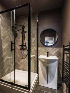 Modern bathroom featuring a sleek black-framed ...