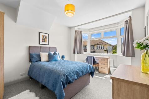 Bright and spacious master bedroom featuring a ...