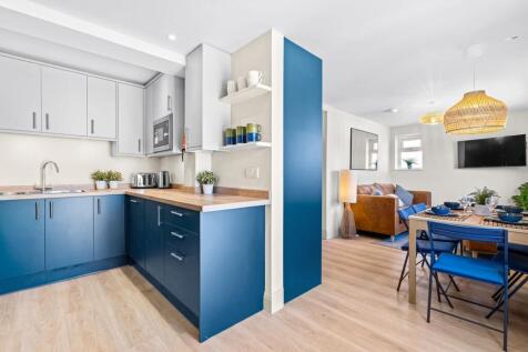 Bright and modern kitchen with stylish blue cab...