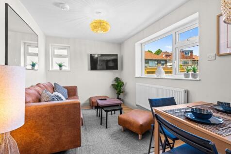 Bright and stylish living room featuring a comf...
