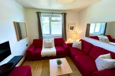 This inviting living room features a cozy arran...