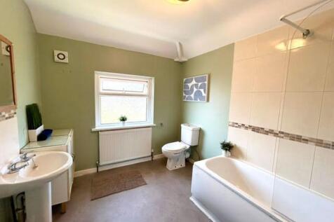 A bright and spacious bathroom suite featuring ...