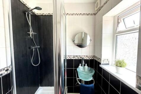 A modern bathroom featuring a stylish shower an...
