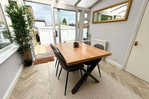 A bright and inviting living room with ample na...