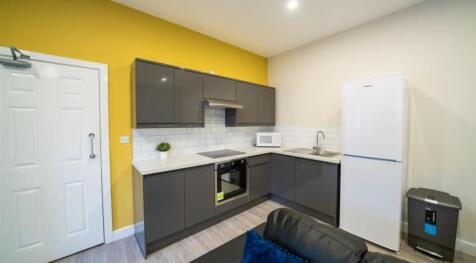This modern kitchen features sleek cabinetry, s...