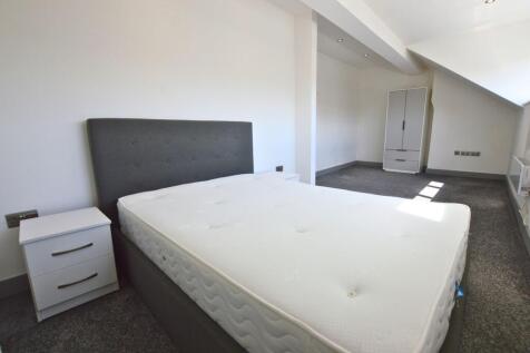 Bright double bedroom featuring a comfortable b...