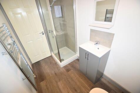 Bright and modern bathroom featuring a walk-in ...