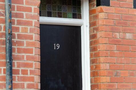 Close-up of the front entrance of a charming br...