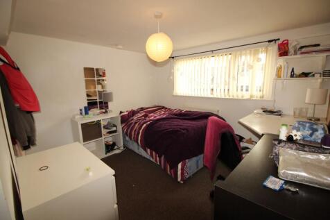 Cozy single bedroom featuring a comfortable bed...
