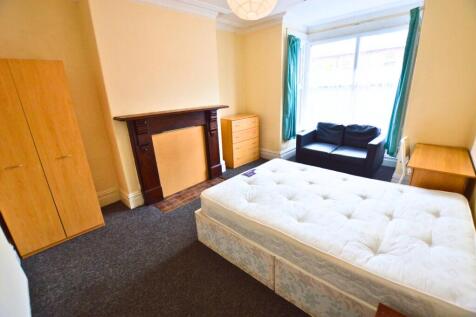 A bright and welcoming master bedroom featuring...