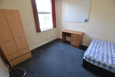 A simple single bedroom featuring a wardrobe an...
