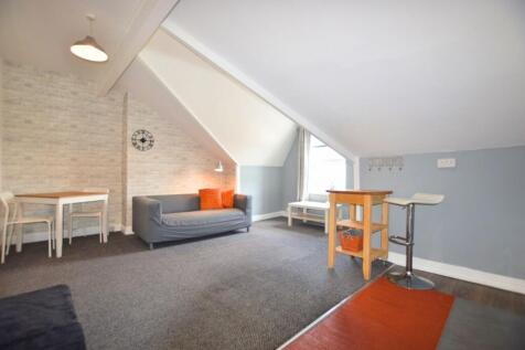 A cozy and well-maintained living room featurin...
