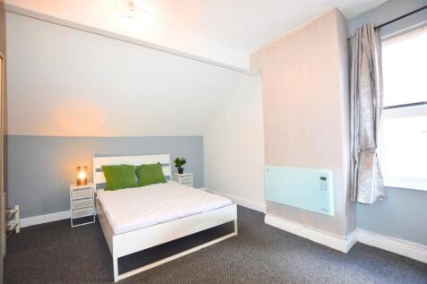 A bright and clean double bedroom featuring a m...