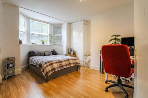 A bright and welcoming double bedroom featuring...