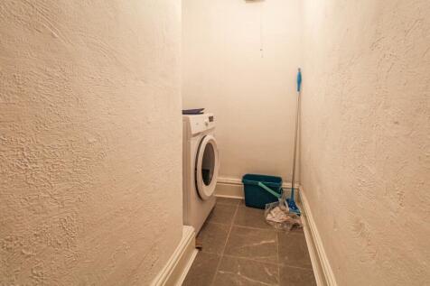 Compact and tidy storage space featuring a wash...