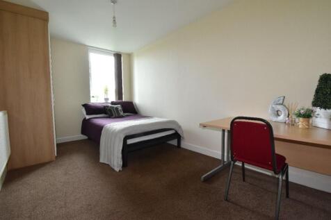 A bright and tidy double bedroom featuring a co...