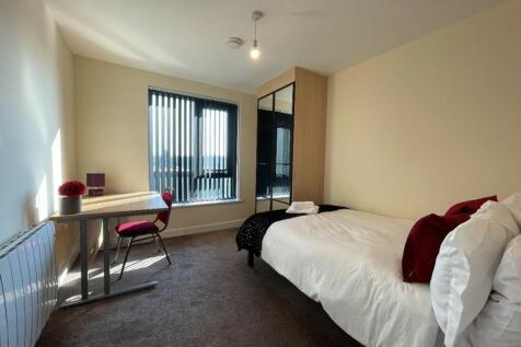 A bright and inviting double bedroom with ample...