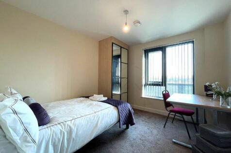 A bright and tidy double bedroom featuring a sc...