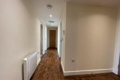 A clean and well-maintained hallway with modern...