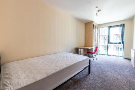 A bright and tidy room featuring a single bed a...