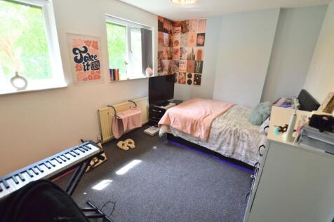 Bright and cozy single bedroom featuring a comf...