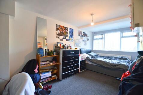A cozy double bedroom featuring a large window ...